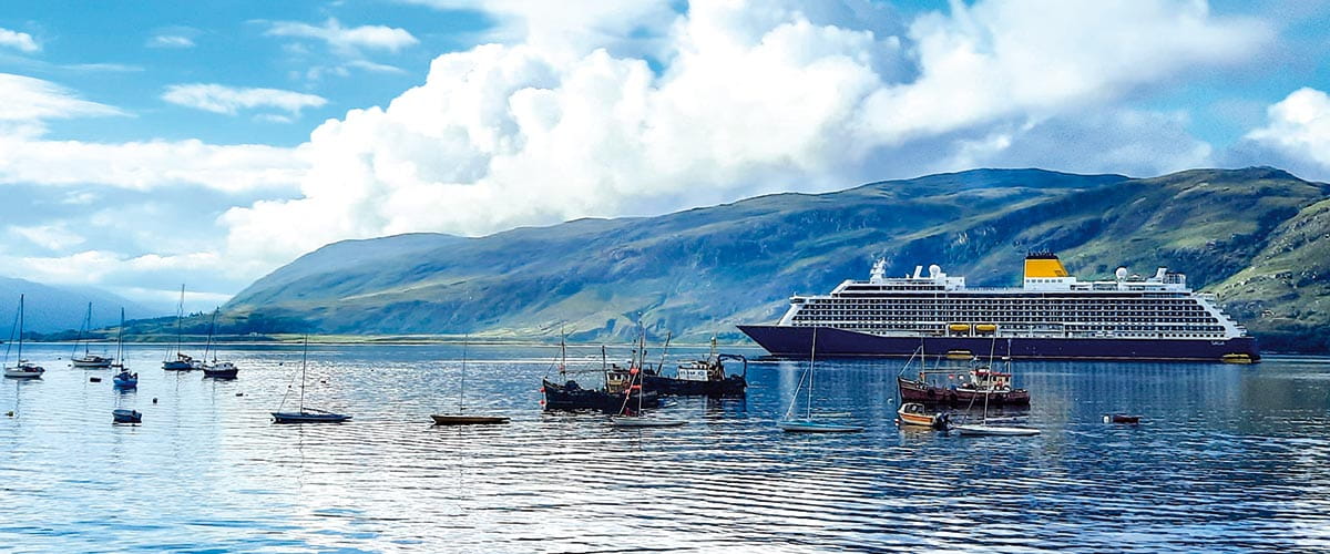 Spirit of Discovery sailing past Loch Broom in Scotland